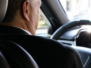 man in black shirt driving car